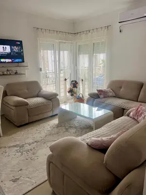 a living room with two couches and a glass table at Vila Dior Donji Stoj in Donji Štoj