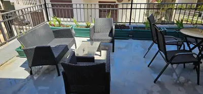 a group of chairs and tables on a patio at Lamour Apartment in Ulcinj