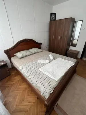 a bedroom with a bed with two towels on it at Lamour Apartment in Ulcinj