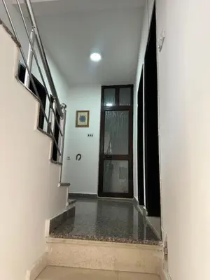 a hallway with stairs and a window in a building at Lamour Apartment in Ulcinj