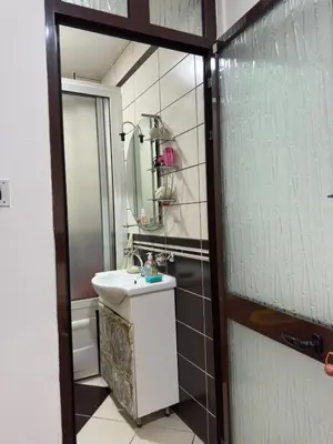 a bathroom with a sink and a mirror at Lamour Apartment in Ulcinj
