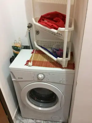a washing machine with a basket on top of it at Small duplex near beach in Sutomore