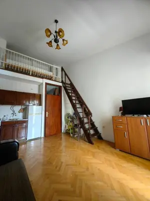 an empty living room with a staircase in a room at Small duplex near beach in Sutomore