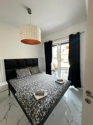 a bedroom with a bed and a chandelier at Ulcinj La Miga2 in Ulcinj