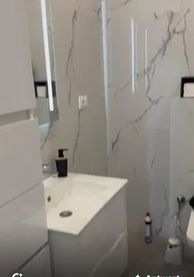 a white bathroom with a sink and a shower at Ulcinj La Miga2 in Ulcinj