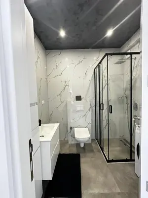 a bathroom with a toilet and a glass shower at Ulcinj La Miga2 in Ulcinj