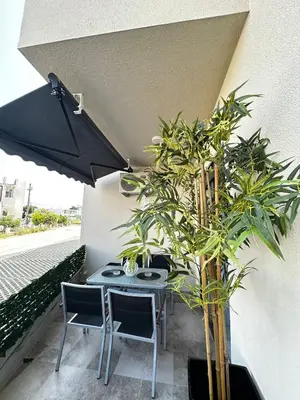a table and chairs with plants on a balcony at Ulcinj La Miga2 in Ulcinj