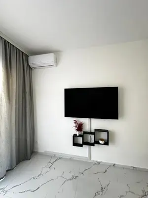 a living room with a flat screen tv on the wall at Ulcinj La Miga2 in Ulcinj