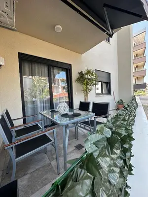 a patio with a table and chairs and plants at Ulcinj La Miga2 in Ulcinj
