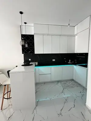a kitchen with white cabinets and marble floors at Ulcinj La Miga2 in Ulcinj