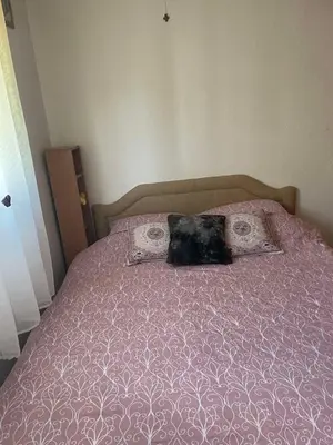 a bed with a purple comforter and two pillows at Trosoban stan in Bar