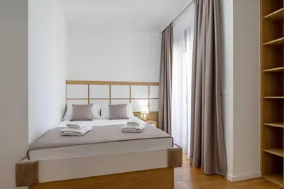 a bedroom with a bed with two towels on it at Apartments BB in Becici