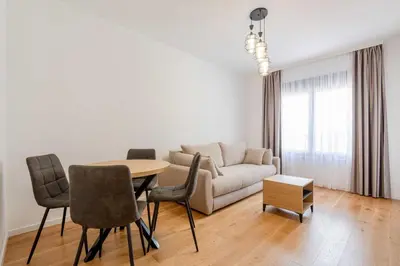 a living room with a couch and a table and chairs at Apartments BB in Becici