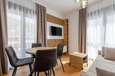 a living room with a table and chairs and a couch at Apartments BB in Becici