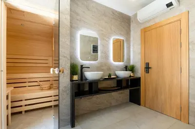a bathroom with two sinks and two mirrors at Apartments BB in Becici