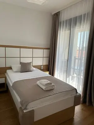 a bedroom with a bed and a large window at Apartments BB in Becici