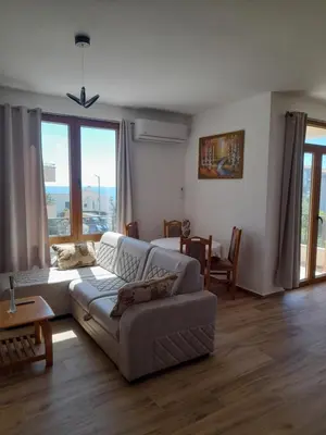 a living room with a couch and a table at Apart SASHENKA 2 in Dobra Voda