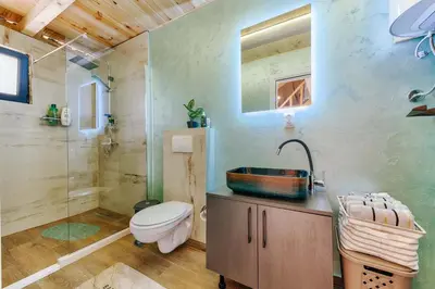 a bathroom with a toilet and a shower and a sink at Olive Hills holiday homes 3 in Dobra Voda