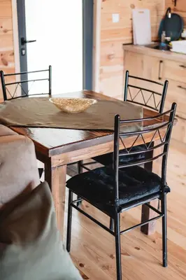 a dining room table with two chairs and a wooden table at Olive Hills holiday homes 3 in Dobra Voda
