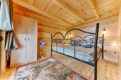 a bedroom with a bed in a log cabin at Olive Hills holiday homes 3 in Dobra Voda