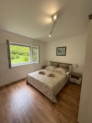 a bedroom with a bed and a window at Boka View Martiva in Kotor