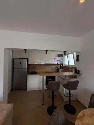 a kitchen with a table and two bar stools at Boka View Martiva in Kotor