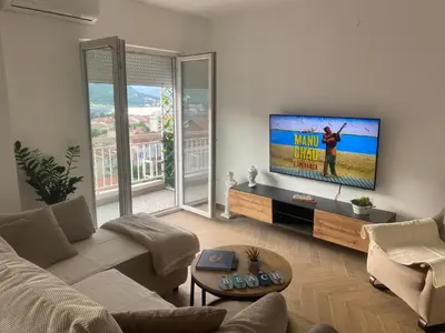 a living room with a couch and a flat screen tv at Boka View Martiva in Kotor