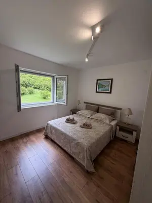 a bedroom with a large bed and a window at Boka View Martiva in Kotor