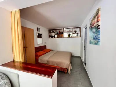 a small bedroom with a bed in a room at Apartments Gvozdenović in Petrovac na Moru