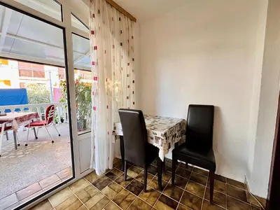 a dining room with a table and two chairs at Apartments Gvozdenović in Petrovac na Moru