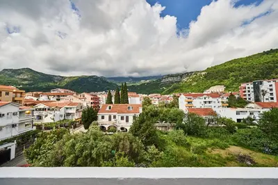 a view of a city with mountains in the background at Family Apartments Mont Budva in Budva