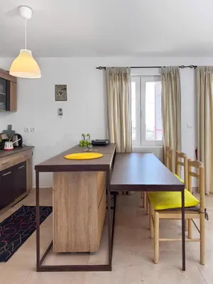 a kitchen and dining room with a table and chairs at Ceres Apartments in Utjeha