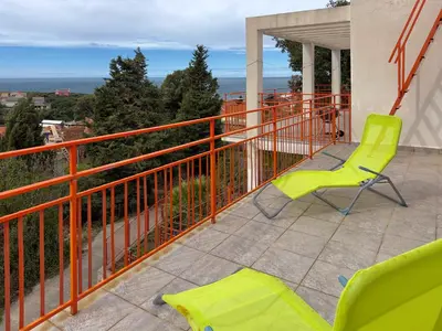 a balcony with two chairs and a view at Ceres Apartments in Utjeha