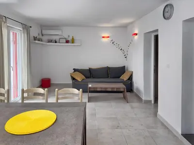 a living room with a blue couch and a table at Ceres Apartments in Utjeha
