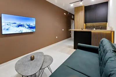 a living room with a couch and a table at Apartments Piano in Utjeha