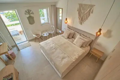 a bedroom with a large bed in a room at Mind Wellness Montenegro in Sveti Stefan