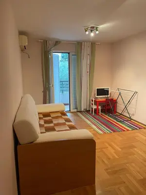 a living room with a couch and a table at One bedroom Apartment in center Budva in Budva
