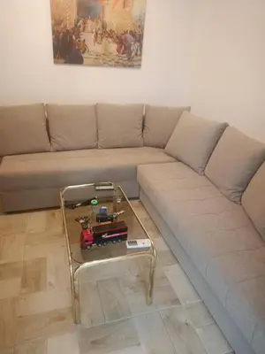 a couch with a coffee table in a living room at Mia apartments in Petrovac near the sea in Petrovac na Moru