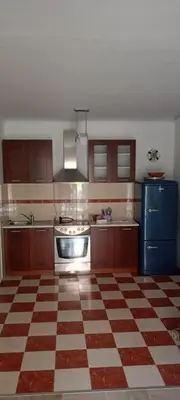 a kitchen with a checkered floor at Mia apartments in Petrovac near the sea in Petrovac na Moru