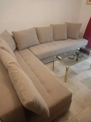 a brown couch in a living room with a coffee table at Mia apartments in Petrovac near the sea in Petrovac na Moru