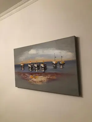 a painting of boats in the water on a wall at Mia apartments in Petrovac near the sea in Petrovac na Moru