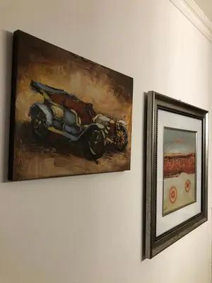 a painting of a motorcycle hanging on a wall at Mia apartments in Petrovac near the sea in Petrovac na Moru