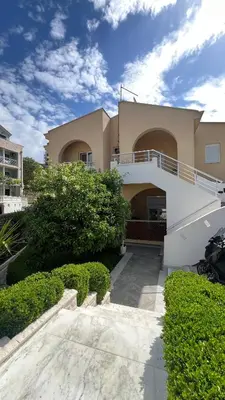 a large house with a balcony on top of it at Golden Sun Apartments in Ulcinj