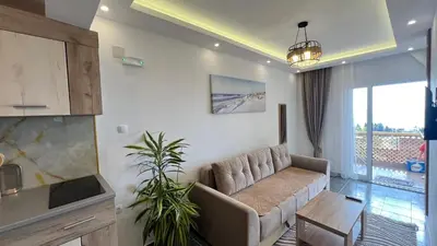 a living room with a couch and a table at Golden Sun Apartments in Ulcinj