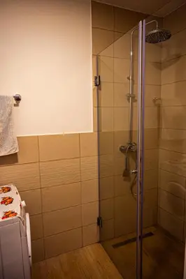 a shower with a glass door in a bathroom at Modern City Flat Budva - Balcony & Garage Included in Budva