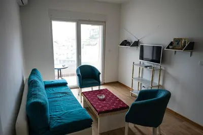 a living room with a couch and two chairs at Modern City Flat Budva - Balcony & Garage Included in Budva
