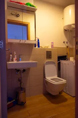 a bathroom with a toilet and a sink at Modern City Flat Budva - Balcony & Garage Included in Budva