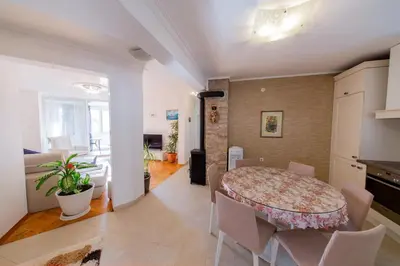 a kitchen and dining room with a table and chairs at Apartment Sambra in Budva