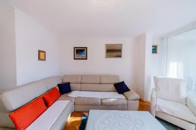 a living room with a couch and two chairs at Apartment Sambra in Budva