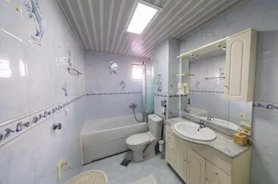 a bathroom with a sink and a toilet and a bath tub at Apartment Sambra in Budva